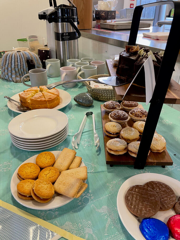 Table of hot drinks, cakes and biscuits